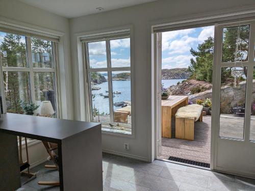 a home office with a view of the water at Svært nydelig fritidshytte in Forland