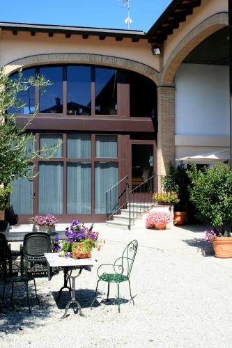 a table and chairs in front of a building at Agriturismo Argaland in Parma