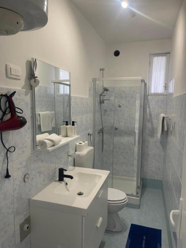 a bathroom with a sink and a toilet and a shower at Retreat Apartments with free parking in Pula