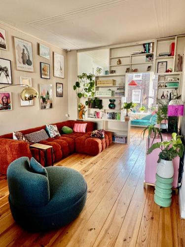 a living room with a couch and a chair at IVY - Classical & modern apartment in lovely neighbourhood near beach in The Hague