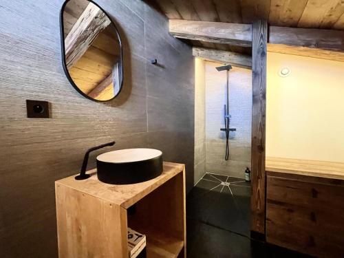 a bathroom with a sink and a mirror at Chalet - Chalets 101 in Notre-Dame-de-Bellecombe
