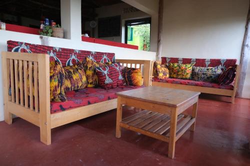 a living room with a couch and a table at Hyena Hill Lodge in Sanga