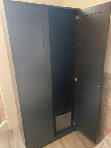 a black cabinet with a drawer in a room at Ferienzimmer (Stanza) in Fondo Trentino in Fondo