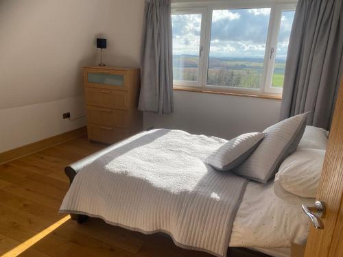 a bedroom with a bed and a window at Immaculate 2 Bed property in rural location in Alloa