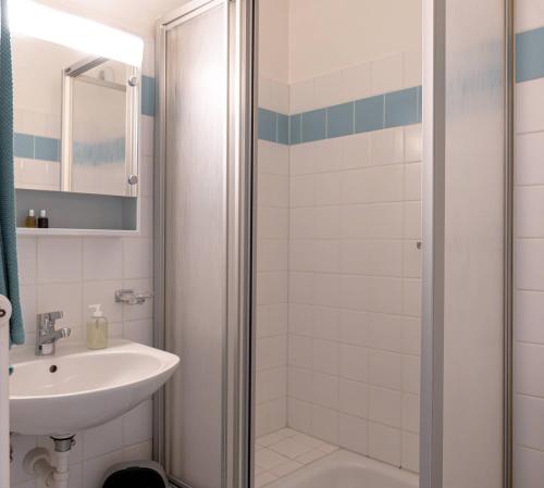 a bathroom with a shower and a sink at Modern studios in the heart of Lausanne in Lausanne