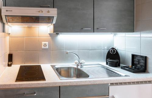 a kitchen with a sink and a stove at Modern studios in the heart of Lausanne in Lausanne