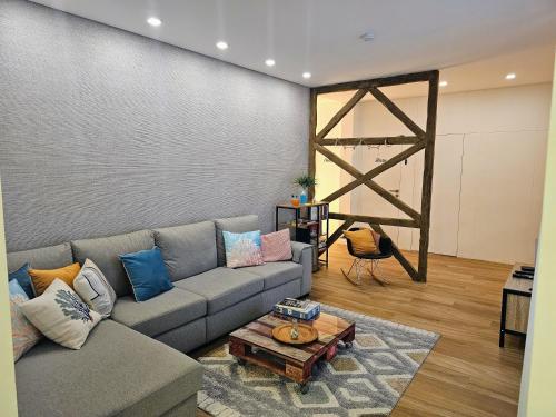 a living room with a couch and a table at SurfSoul Guesthouse - Bed and Breakfast in Peniche