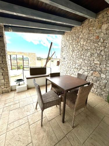 a dining room with a table and chairs and a piano at Egò Salento in Galatina
