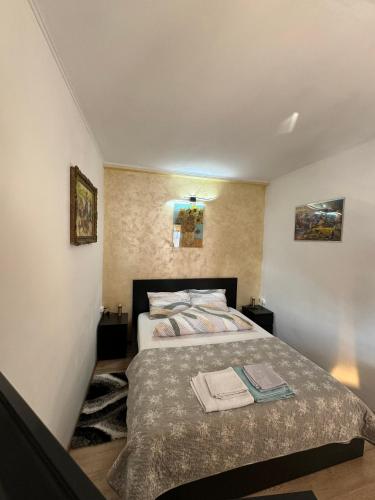 a bedroom with a bed with two towels on it at Victor Residence 38 in Bucharest