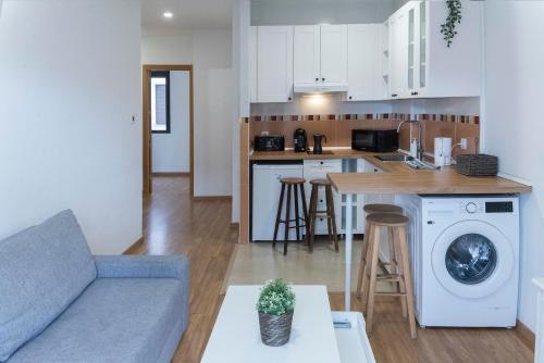 a living room with a couch and a kitchen at San Justo 3 in Huelva