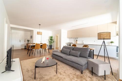 a living room with a couch and a table at Feliciano Ramos 3 - T4 familiar perto do centro da cidade - Braga in Braga