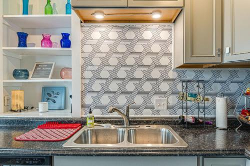 a kitchen with a sink and a tile wall at Pet-Friendly Indianapolis Retreat Near City Center in Indianapolis