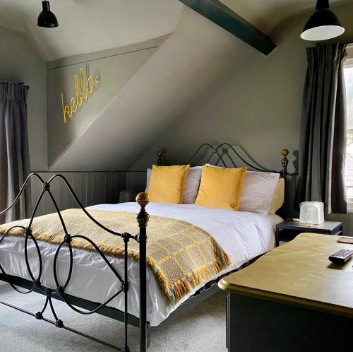 a bedroom with a bed with yellow pillows at Crafnant House - Bed & Breakfast in Trefriw