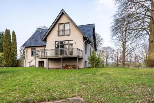 a large white house with a large yard at Buchenhof in Delingsdorf