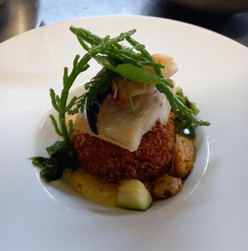 a white plate with a piece of food on it at Orchard Lodge & Wolds Restaurant in Cayton