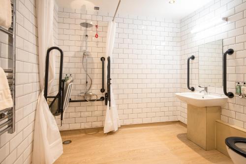 a bathroom with a shower and a sink at The Stables - The Inn Collection Group in Whitby