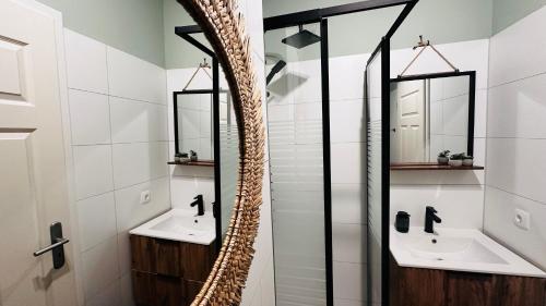ein Badezimmer mit zwei Waschbecken und zwei Spiegeln in der Unterkunft Apartment FAUNA in Halle an der Saale in Halle an der Saale