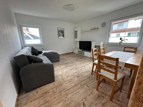 ein Wohnzimmer mit einem Tisch und einem Sofa sowie ein Esszimmer in der Unterkunft Ferienwohnung Bergoase in Goslar