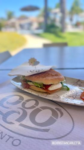 a sandwich sitting on a plate on a table at Egò Salento in Galatina