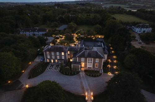 an aerial view of a large house with lights at Newbay House Wexford in Wexford