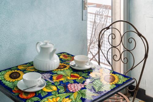 a table with a tea pot and two cups on it at Dream Suite in Milan