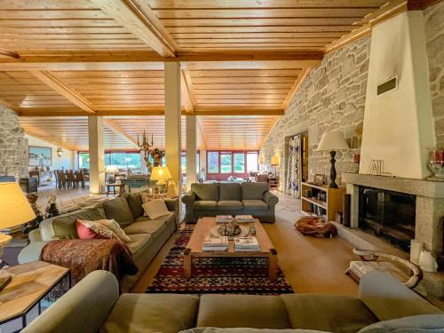 a large living room with couches and a fireplace at Casa Justininho in Ponte de Lima