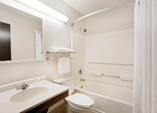 a white bathroom with a sink and a toilet at Super 8 by Wyndham Waynesboro in Waynesboro