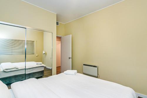 a bedroom with two beds and a mirror at SEA VIEW HOTEL APART in Baku