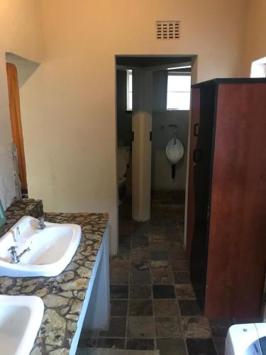 a bathroom with a sink and a toilet at Dullstroom on the Dam Backpackers in Dullstroom