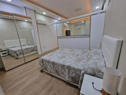 a bedroom with a bed and a large window at Aquí es in Badajoz