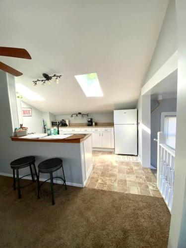 a kitchen with two stools and a counter with a refrigerator at Quiet 1 Bedroom in Rock Island, IL. in Rock Island