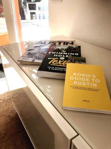 two books are sitting on a glass counter at Cozy Cabin w Pvt Heated Pool Under Epic TX Stars in Dripping Springs