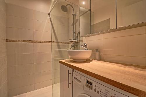 une salle de bain avec un lavabo et une machine à laver dans l'établissement Appartement plein centre proche Palais et plages, à Cannes