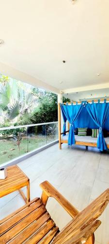 a room with a couch and a table and chairs at Blue Mango Beach Hotel in Guachaca