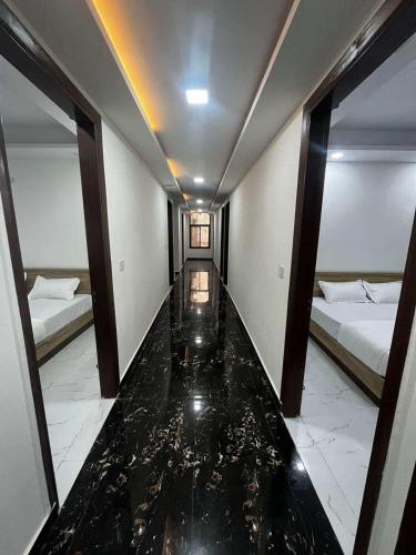 a hallway with two beds and a glass floor at Hotel Silver Crown in New Delhi