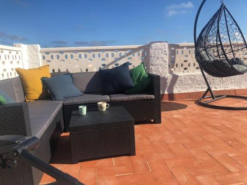 a couch sitting on top of a patio at Villa Casa Queen in Mojácar