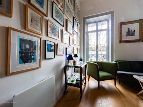 a living room with a couch and pictures on the wall at L'artiste - Coeur de ville in Montpellier