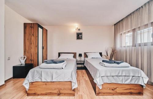 a bedroom with two beds and a window at Вила Фреди in Varna City