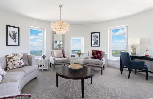 a living room with a couch and chairs and a table at Fairmont Le Chateau Frontenac in Quebec City
