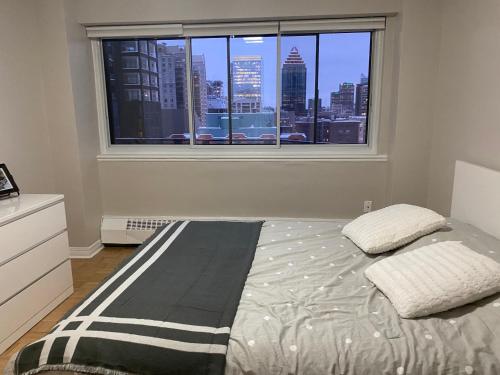 um quarto com uma cama e uma janela com vista em House crescent em Montreal