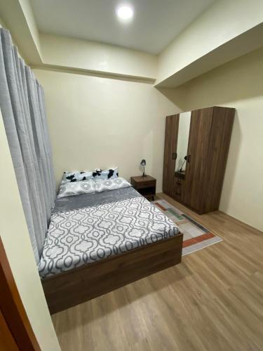 a bedroom with a bed in a room at Northwoods Place Studio Unit in Mandaue City