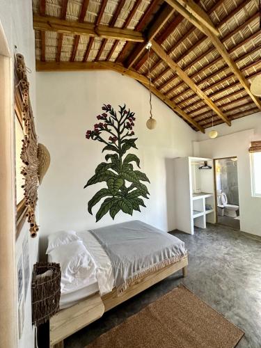 a bedroom with a bed with a plant on the wall at Kite House Cabarete across Kite Beach in Cabarete