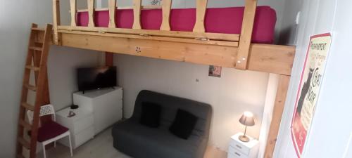 - une chambre avec des lits superposés et un canapé dans l'établissement Appartement calme aux abords de Paris, Seine, à Boulogne-Billancourt