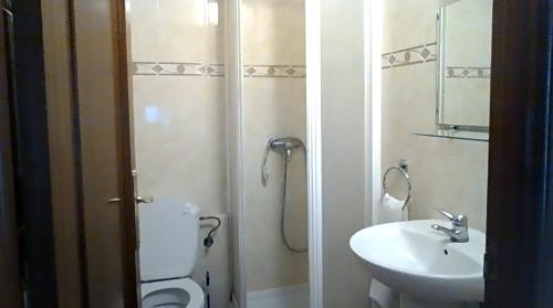 a bathroom with a toilet and a sink at hostal restaurante galicia in Villardefrades