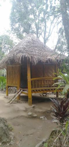a small hut with a straw roof at Pù Luông JUNGLE KING 1 HOMESTAY in Pu Luong
