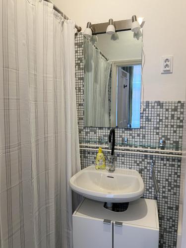 bagno con lavandino e specchio di Home in the centre of Budapest a Budapest