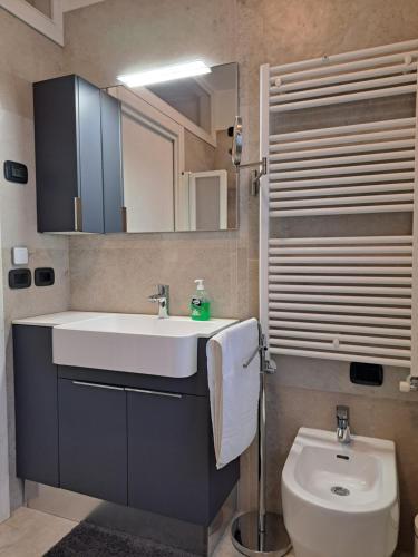 a bathroom with a sink and a toilet and a mirror at Borgo Barucchella in SantʼAndrà