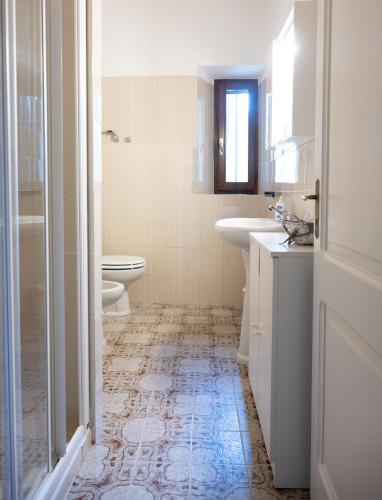a bathroom with a toilet and a sink and a toilet at B&B CorteBonomini entire home in Sasso