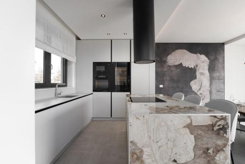 a kitchen with white cabinets and a marble counter at Villa Bella Ciao by SeeAdria Agency in Novigrad Istria