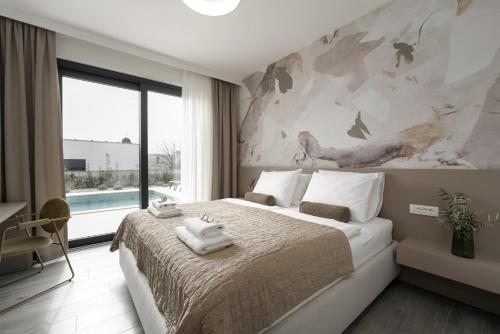 a bedroom with a large bed and a large window at Villa Bella Ciao by SeeAdria Agency in Novigrad Istria